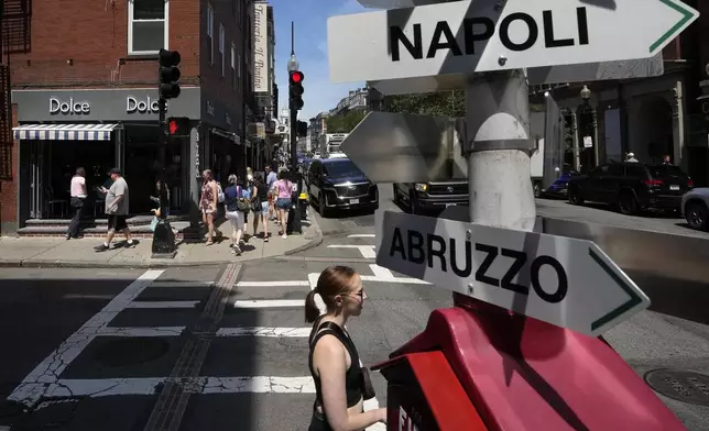 Passers-by make their way along a street in Boston's historic North End neighborhood, Wednesday, July 3, 2024. A long Fourth of July holiday weekend in the United States is expected to create new travel records. (AP Photo/Steven Senne)