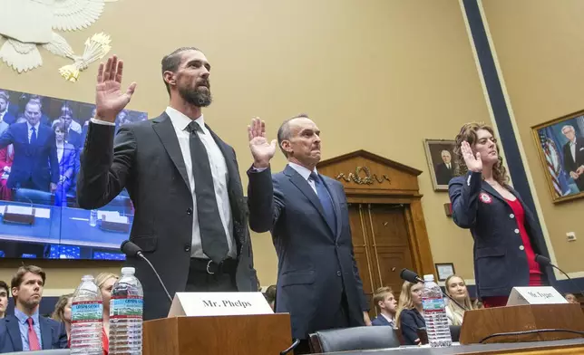 Michael Phelps, former Olympic athlete, left, Travis Tygart, Chief Executive Officer of the U.S. Anti-Doping Agency, center, and Allison Schmitt, former Olympic athlete, are sworn in during a House Committee on Energy and Commerce Subcommittee on Oversight and Investigations hearing examining Anti-Doping Measures in Advance of the 2024 Olympics, on Capitol Hill, Tuesday, June 25, 2024, in Washington. (AP Photo/Rod Lamkey, Jr.)