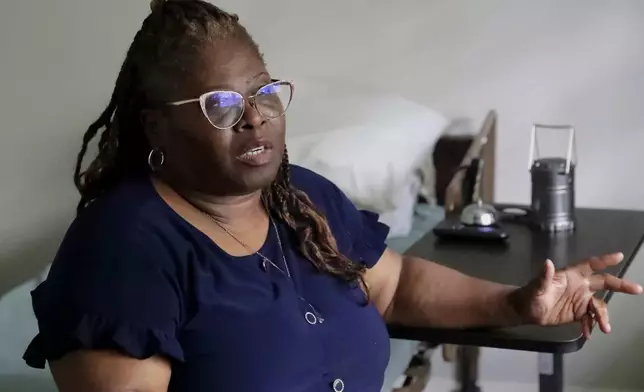 Janet Jarrett speaks in the bedroom of her sister, Pamela Jarrett, who passed away after suffering heat related distress due to the power outage caused by hurricane Beryl, Friday, July 19, 2024, in Spring, Texas. (AP Photo/Michael Wyke)