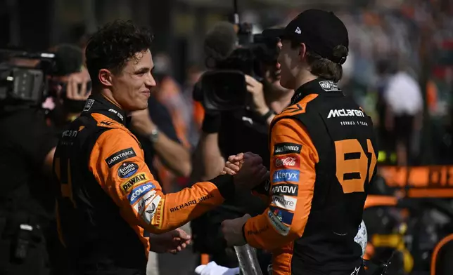 McLaren driver Lando Norris of Britain, left, congratulates McLaren driver Oscar Piastri of Australia on his win at the Hungarian Formula One Grand Prix race at the Hungaroring racetrack in Mogyorod, Hungary, Sunday, July 21, 2024. (AP Photo/Denes Erdos)