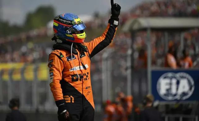 McLaren driver Oscar Piastri of Australia celebrates after winning the Hungarian Formula One Grand Prix race at the Hungaroring racetrack in Mogyorod, Hungary, Sunday, July 21, 2024. (AP Photo/Denes Erdos)