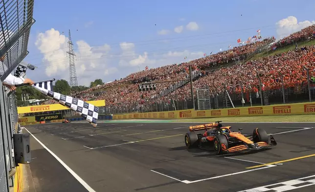 McLaren driver Oscar Piastri of Australia crosses the finish line to win the Hungarian Formula One Grand Prix race at the Hungaroring racetrack in Mogyorod, Hungary, Sunday, July 21, 2024. (Martin Divisek/Pool Photo via AP)