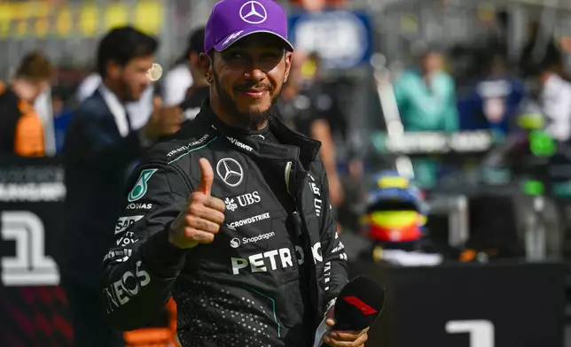 Mercedes driver Lewis Hamilton of Britain celebrates his third place at the Hungarian Formula One Grand Prix race at the Hungaroring racetrack in Mogyorod, Hungary, Sunday, July 21, 2024. (AP Photo/Denes Erdos)