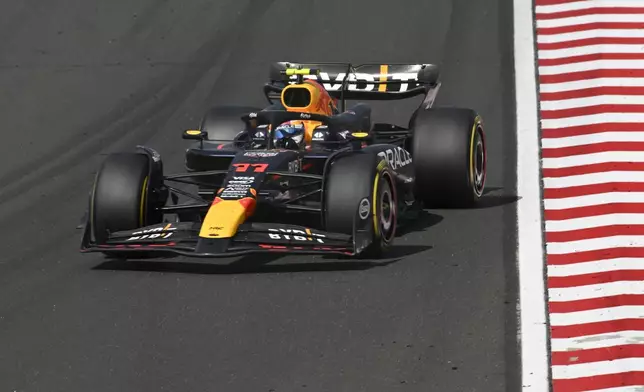 Red Bull driver Sergio Perez of Mexico steers his car during the Hungarian Formula One Grand Prix race at the Hungaroring racetrack in Mogyorod, Hungary, Sunday, July 21, 2024. (AP Photo/Denes Erdos)