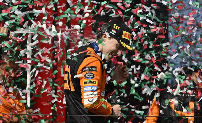 McLaren driver Oscar Piastri of Australia celebrates on the podium after winning the Hungarian Formula One Grand Prix race at the Hungaroring racetrack in Mogyorod, Hungary, Sunday, July 21, 2024. (AP Photo/Denes Erdos)