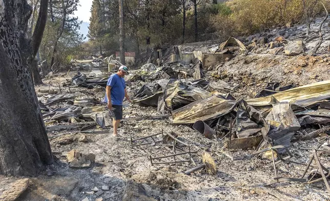 Joseph Phillips stands where the front door of his home once stood before the Gwen Fire tore through the area and destroyed the home, Saturday, July 27, 2024, off of Gifford Reubens Road, Idaho. (August Frank/Lewiston Tribune via AP)