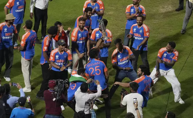 India's cricket players dance during a ceremony at Wankhede Stadium, Thursday, July 4, 2024, in Mumbai, India, celebrating their ICC Men's Twenty20 World Cup win. (AP Photo/Rafiq Maqbool)