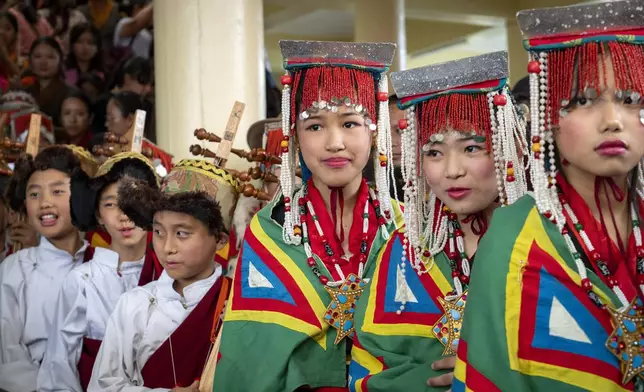 Exiled Tibetans in ceremonial outfits wait to perform a traditional dance at an event to celebrate the 89th birthday of Tibetan spiritual leader the Dalai Lama at the Tsuglakhang temple in Dharamshala, India, Saturday, July 6, 2024. (AP Photo/Ashwini Bhatia)