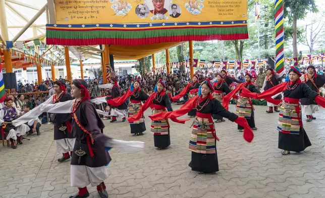 Exile Tibetans in a ceremonial dress perform a traditional dance at an event to celebrate the 89th birthday of Tibetan spiritual leader the Dalai Lama at the Tsuglakhang temple in Dharamshala, India, Saturday, July 6, 2024. (AP Photo/Ashwini Bhatia)