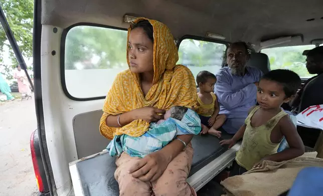 25-year-old Jahanara Khatoon nurses her newborn daughter, born on a boat over the river Brahmaputra, as the family sits inside an ambulance on the way to a healthcare centre in Morigaon district, in the northeastern Indian state of Assam, Wednesday, July 3, 2024. (AP Photo/Anupam Nath)