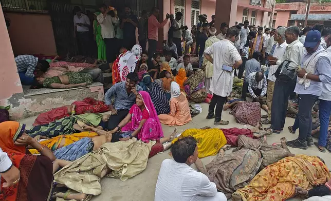 Relatives mourn next to the bodies of their relatives outside the Sikandrarao hospital in Hathras district about 350 kilometers (217 miles) southwest of Lucknow, India, Tuesday, July 2, 2024. Thousands of people at a religious gathering in India rushed to leave a makeshift tent, setting off a stampede Tuesday that killed more than hundred people and injured scores. (AP Photo)