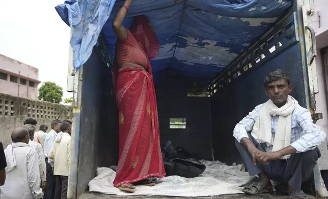 Family members accompany the body of Savitri Devi, 50, who died during a stampede, after receiving it from a mortuary to be taken home for her final rites, near Hathras, in the northern Indian state of Uttar Pradesh, Wednesday, July 3, 2024. Devi was among more than 120 people who died in a stampede last week at a religious festival in northern India, as the faithful surged toward the preacher and chaos ensued among the attendees. (AP Photo/Rajesh Kumar Singh)