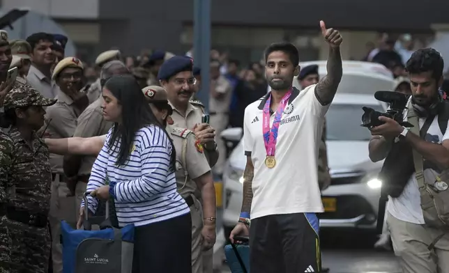 India's Suryakumar Yadav greets fans as he arrives at the Indira Gandhi International Airport in New Delhi, India, Thursday, July 4, 2024. Indian cricket team returned Thursday after winning the T20 Cricket World Cup hosted by the United States and the West Indies. (AP Photo)