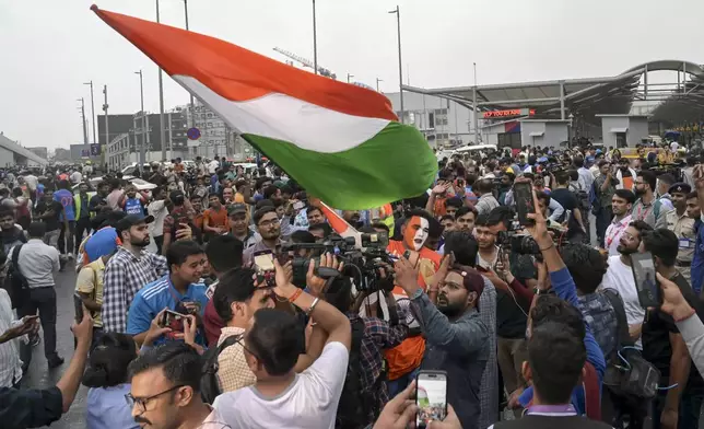 Fans gather outside the Indira Gandhi International Airport to get a glimpse of the Indian cricket players before they returned Thursday after winning the T20 Cricket World Cup, in New Delhi, India, Thursday, July 4, 2024. (AP Photo)