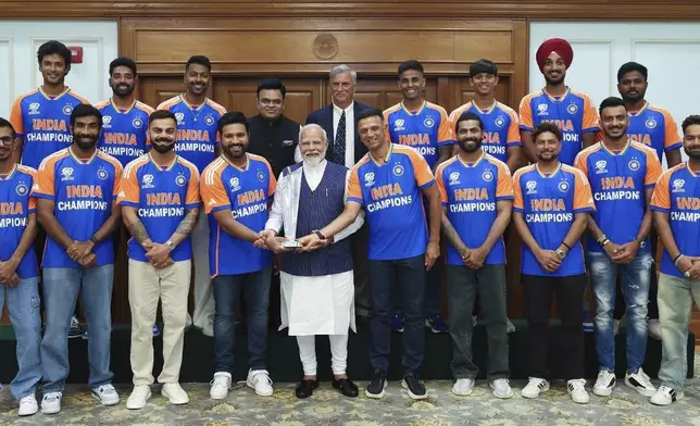 In this images shared on X by the official page of the Indian Prime Minister Narendra Modi, Modi holds the Twenty20 World Cup trophy as he poses with the Indian cricket team at his residence in New Delhi, India, Thursday, July 4, 2024. Jubilant India cricketers received a rousing welcome home Thursday after winning the Twenty20 World Cup final in Barbados. (Narendra Modi on X via AP)