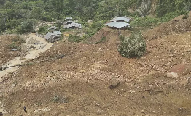 In this photo released by the Indonesian National Search and Rescue Agency (BASARNAS), rescuers search for victims at the site of a landslide in Bone Bolango in Gorontalo province, Indonesia, Wednesday, July 10, 2024. Search efforts for those trapped in a deadly landslide intensified Wednesday, with more rescuers deployed to search an unauthorized gold mine on Indonesia's Sulawesi island that saw a number of deaths over the weekend. (BASARNAS via AP)