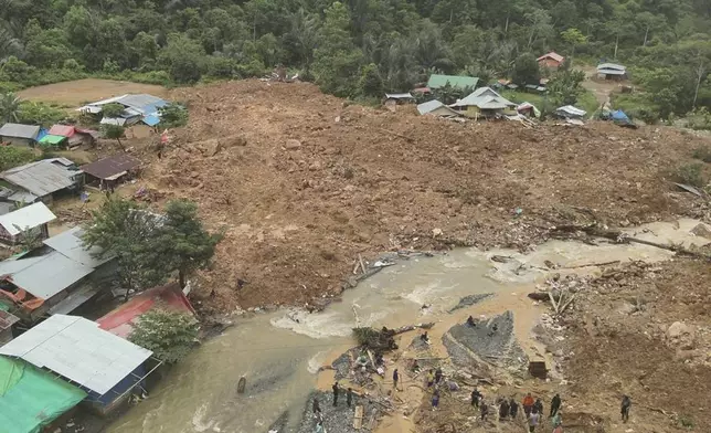 In this photo released by the Indonesian National Search and Rescue Agency (BASARNAS), rescuers search for victims at the site of a landslide in Bone Bolango in Gorontalo province, Indonesia, Wednesday, July 10, 2024. Search efforts for those trapped in a deadly landslide intensified Wednesday, with more rescuers deployed to search an unauthorized gold mine on Indonesia's Sulawesi island that saw a number of deaths over the weekend. (BASARNAS via AP)