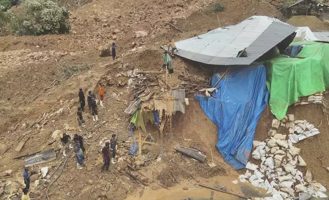 In this photo released by the Indonesian National Search and Rescue Agency (BASARNAS), rescuers search for victims at the site of a landslide in Bone Bolango in Gorontalo province, Indonesia, Wednesday, July 10, 2024. Search efforts for those trapped in a deadly landslide intensified Wednesday, with more rescuers deployed to search an unauthorized gold mine on Indonesia's Sulawesi island that saw a number of deaths over the weekend. (BASARNAS via AP)