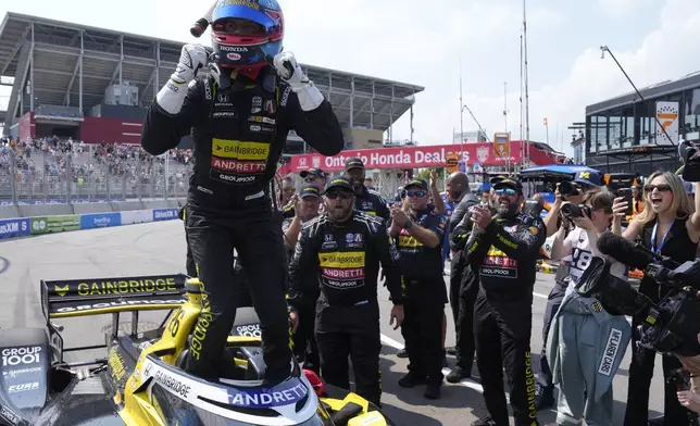 Colton Herta, left, of the United States, celebrates with his team after winning an IndyCar auto race in Toronto, Sunday, July 21, 2024. (Frank Gunn/The Canadian Press via AP)