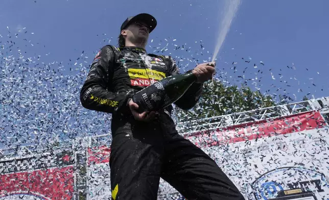 Colton Herta, of the United States, celebrates with his team after winning an IndyCar auto race in Toronto, Sunday, July 21, 2024. (Frank Gunn/The Canadian Press via AP)