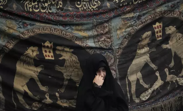 A Shiite Muslim woman attends Ashoura mourning ritual, commemorating the 7th century martyrdom of Prophet Muhammad's grandson, Hussein, in the battle of Karbala in present-day Iraq, at the old main bazaar of Tehran, Iran, Tuesday, July 16, 2024. Shiites represent over 10% of the world's 1.8 billion Muslims and view Hussein as the rightful successor to the Prophet Muhammad. (AP Photo/Vahid Salemi)