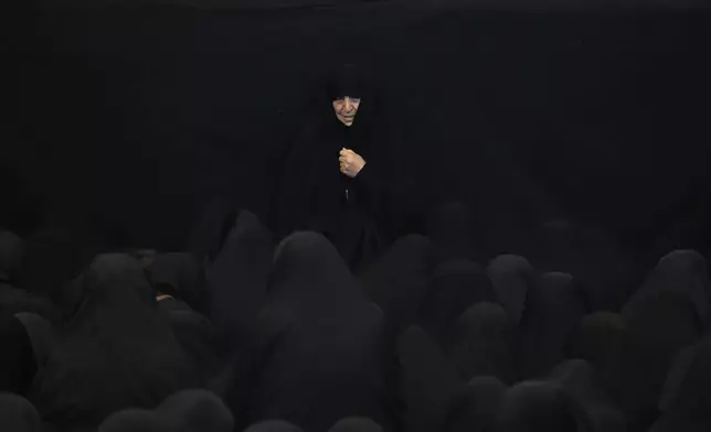 Iranian Shiite Muslims mourn during Ashoura ritual, commemorating the 7th century martyrdom of Prophet Muhammad's grandson, Hussein, in the battle of Karbala in present-day Iraq, at the old main bazaar of Tehran, Iran, Tuesday, July 16, 2024. Shiites represent over 10% of the world's 1.8 billion Muslims and view Hussein as the rightful successor to the Prophet Muhammad. (AP Photo/Vahid Salemi)