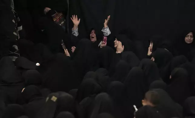 Iranian Shiite Muslims mourn during Ashoura ritual, commemorating the 7th century martyrdom of Prophet Muhammad's grandson, Hussein, in the battle of Karbala in present-day Iraq, at the old main bazaar of Tehran, Iran, Tuesday, July 16, 2024. Shiites represent over 10% of the world's 1.8 billion Muslims and view Hussein as the rightful successor to the Prophet Muhammad. (AP Photo/Vahid Salemi)