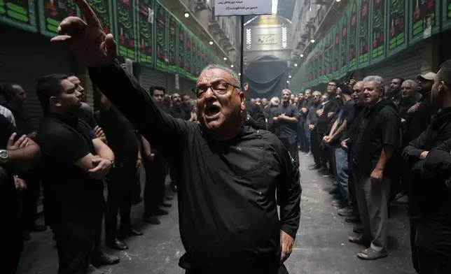 Iranian Shiite Muslims mourn during Ashoura ritual, commemorating the 7th century martyrdom of Prophet Muhammad's grandson, Hussein, in the battle of Karbala in present-day Iraq, at the old main bazaar of Tehran, Iran, Tuesday, July 16, 2024. Shiites represent over 10% of the world's 1.8 billion Muslims and view Hussein as the rightful successor to the Prophet Muhammad. (AP Photo/Vahid Salemi)