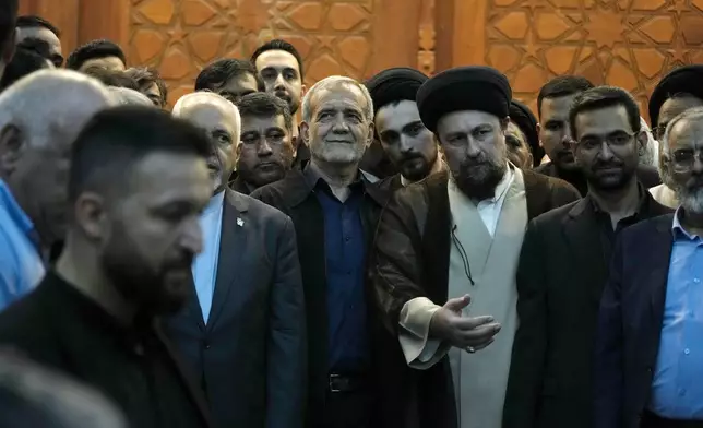 Iran's President-elect Masoud Pezeshkian, center, arrives to attend a meeting a day after the presidential election, at the shrine of the late revolutionary founder Ayatollah Khomeini, just outside Tehran, Iran, Saturday, July 6, 2024. (AP Photo/Vahid Salemi)