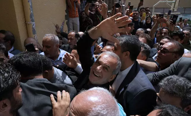 Reformist candidate for the Iran's presidential election Masoud Pezeshkian waves as he arrives to vote at a polling station in Shahr-e-Qods near Tehran, Iran, Friday, July 5, 2024. Iranians began voting Friday in a runoff election to replace the late President Ebrahim Raisi, killed in a helicopter crash last month, as public apathy has become pervasive in the Islamic Republic after years of economic woes, mass protests and tensions in the Middle East. (AP Photo/Vahid Salemi)