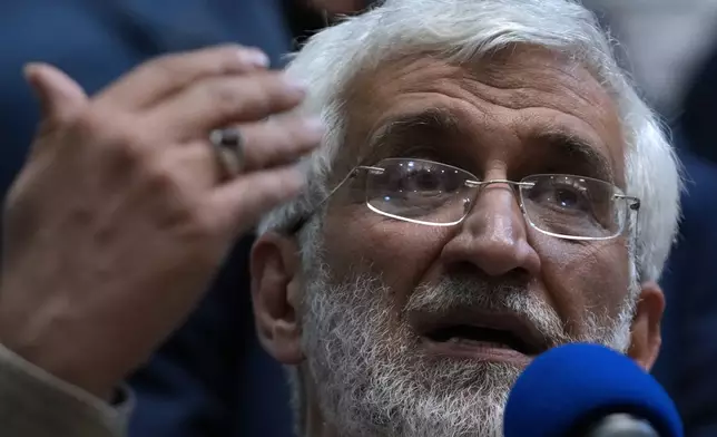 Iranian presidential candidate Saeed Jalili, a hard-line former nuclear negotiator, speaks to a group of athlete supporters during a campaign stop at a sports hall in Tehran, Iran, Sunday, June 30, 2024. (AP Photo/Vahid Salemi)