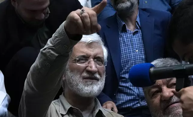 Iranian presidential candidate Saeed Jalili, a hard-line former nuclear negotiator, gestures while meeting with a group of athlete supporters during a campaign stop at a sports hall in Tehran, Iran, Sunday, June 30, 2024. (AP Photo/Vahid Salemi)