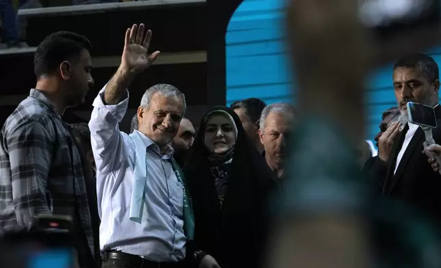 Iranian presidential candidate Masoud Pezeshkian waves to his supporters while campaigning in Tehran, Iran, Sunday, June 23, 2024. (AP Photo/Vahid Salemi)