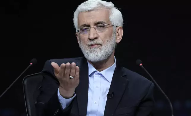 In this photo made available by Iranian state-run TV, IRIB, Iranian presidential candidate Saeed Jalili, a hard-line former nuclear negotiator, speaks during a debate with reformist candidate Masoud Pezeshkian at the TV studio in Tehran, Iran, Monday, July 1, 2024. (Morteza Fakhri Nezhad/IRIB via AP)