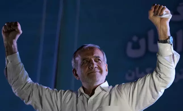 Reformist candidate for the Iran's presidential election Masoud Pezeshkian clenches his fists during a campaign rally in Tehran, Iran, Wednesday, July 3, 2024. (AP Photo/Vahid Salemi)