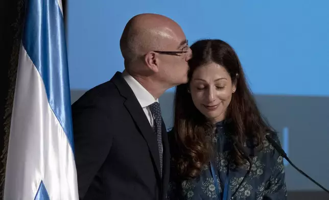 Martin and Ilana Moshav on the podium at the inauguration of The Moshal Shoah Legacy Campus and The David and Fela Shapell Family Collections Center, at Yad Vashem World Holocaust Remembrance Center in Jerusalem, Monday, July 8, 2024. Israel's national Holocaust museum opened a new conservation facility in Jerusalem, which will preserve, restore, and store the more than 45,000 artifacts and works of art in a vast new building, including five floors of underground storage. (AP Photo/Maya Alleruzzo)