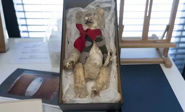 A teddy bear is displayed in a textiles conservation lab during the inauguration of The Moshal Shoah Legacy Campus and The David and Fela Shapell Family Collections Center, at Yad Vashem World Holocaust Remembrance Center in Jerusalem, Monday, July 8, 2024. Israel's national Holocaust museum opened a new conservation facility in Jerusalem, which will preserve, restore, and store the more than 45,000 artifacts and works of art in a vast new building, including five floors of underground storage. (AP Photo/Maya Alleruzzo)