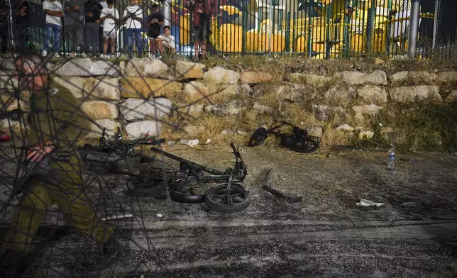 Destroyed children's bicycles at the site of a rocket attack in the Druze town of Majdal Shams, in the Israeli-controlled Golan Heights, Saturday, July 27, 2024. (AP Photo/Gil Eliyahu)