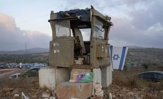 An Israeli soldiers prays in the Eviatar outpost in the Israeli-occupied West Bank during morning prayers calling for the legalization of the outpost and the return of the hostages held in the Gaza Strip by the Hamas militant group, Sunday, July 7, 2024. Far-right ministers in Israel’s government have said they want to legalize unauthorized outposts in the West Bank in a sweeping expansion of settlements. (AP Photo/Ohad Zwigenberg)