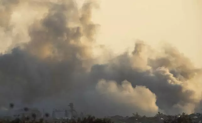 Smoke rises following an explosion in the Gaza Strip as seen from southern Israel, Tuesday, July 23, 2024. The army is battling Palestinian militants across Gaza in the war ignited by Hamas' Oct. 7 attack into Israel. (AP Photo/Ohad Zwigenberg)