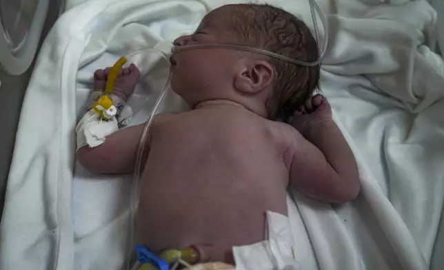 A Palestinian baby boy, not yet named, who was delivered prematurely after his mother Ola al-Kurd was killed in an Israeli strike, lies in an incubator at a hospital in Deir al-Balah, Friday, July 19, 2024. The latest casualties follow a rare moment of hope in war ravaged Gaza, after a medical teams recovered a live baby from a heavily pregnant Palestinian mother killed in an airstrike that hit her home in Nuseirat late Thursday evening. The still-unnamed newborn is stable but has suffered from a shortage of oxygen and has been placed in an incubator, doctors said. (AP Photo/Abdel Kareem Hana)