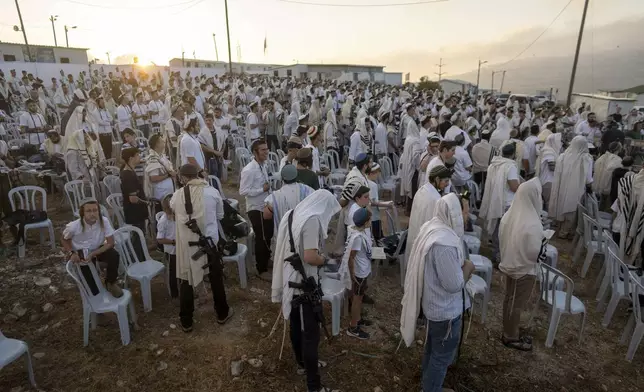 Jewish settlers pray in the Eviatar outpost in the Israeli-occupied West Bank during morning prayers calling for the legalization of the outpost and the return of the hostages held in the Gaza Strip by the Hamas militant group, Sunday, July 7, 2024. Far-right ministers in Israel’s government have said they want to legalize unauthorized outposts in the West Bank in a sweeping expansion of settlements. (AP Photo/Ohad Zwigenberg)