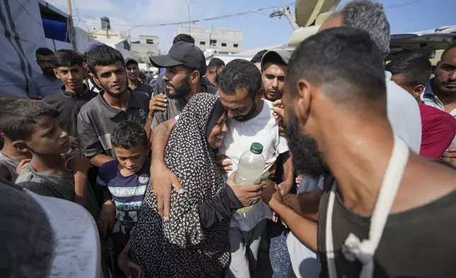 Palestinians who were arrested in the Gaza Strip by the Israeli military and released through the Kissufim crossing point are welcomed by relatives at a hospital in Deir al Balah, central Gaza Strip on Monday, July 1, 2024. (AP Photo/Abdel Kareem Hana)