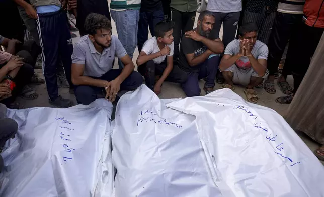 Palestinians mourn relatives killed by Israeli bombardment in Khan Younis, southern Gaza Strip, Saturday, July 6, 2024. (AP Photo/Jehad Alshrafi)