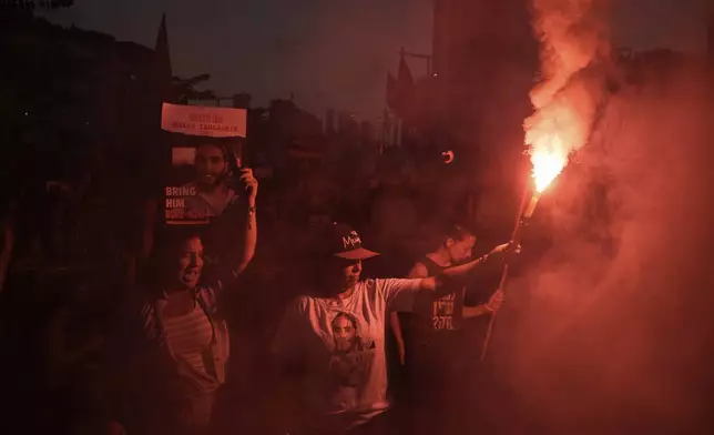 People attend a protest marking nine months since the start of the war and calling for the release of hostages held in the Gaza Strip by the Hamas militant group, in Tel Aviv, Israel, Sunday, July 7, 2024. (AP Photo/Leo Correa)