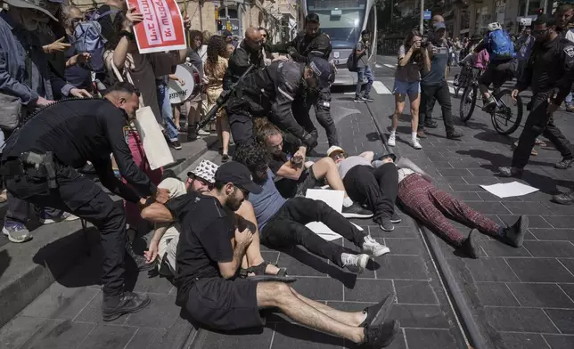 Police disperse demonstrators blocking a road during a protest marking nine months since the start of the war and calling for the release of hostages held in the Gaza Strip by the Hamas militant group, in Jerusalem, Sunday, July 7, 2024. (AP Photo/Mahmoud Illean)