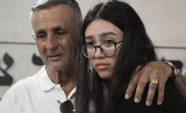 Freed Israeli hostage Noa Argamani, right, comforts her father Yakov, during the funeral for his wife and her mother Liora Argamani, in Beersheba, Israel, Tuesday, July 2, 2024. Liora Argamani, 61, who had stage four brain cancer, had pleaded for the release of her daughter, Noa, saying she wanted to see her only child before she died. (AP Photo/Tsafrir Abayov)