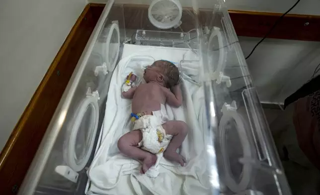 A Palestinian baby boy, not yet named, who was delivered prematurely after his mother Ola al-Kurd was killed in an Israeli strike, lies in an incubator at a hospital in Deir al-Balah, Friday, July 19, 2024. The latest casualties follow a rare moment of hope in war ravaged Gaza, after a medical teams recovered a live baby from a heavily pregnant Palestinian mother killed in an airstrike that hit her home in Nuseirat late Thursday evening. The still-unnamed newborn is stable but has suffered from a shortage of oxygen and has been placed in an incubator, doctors said. (AP Photo/Abdel Kareem Hana)