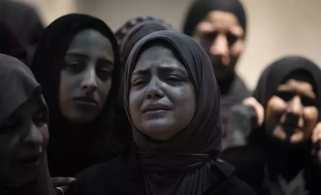 Mourners attend the funeral of Muhammad Sarhan,15, in the West Bank town of Tulkarem on Tuesday, July 2, 2024. Palestinian health officials say Sarhan and another woman were shot and killed, and four people were wounded by Israeli forces during a raid in the northern West Bank on Monday. (AP Photo/Majdi Mohammed)