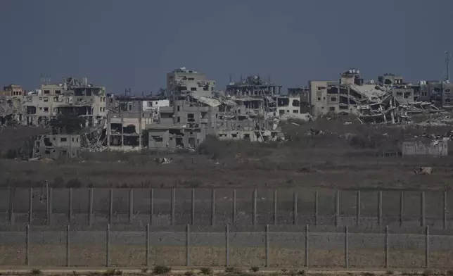 Destroyed buildings stand in the Gaza Strip, seen from southern Israel, Wednesday, July 24, 2024. (AP Photo/Tsafrir Abayov)